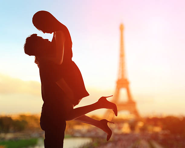 Romantic lovers with eiffel tower silhouette of romantic lovers with eiffel tower in Paris with sunset paris france eiffel tower love kissing stock pictures, royalty-free photos & images