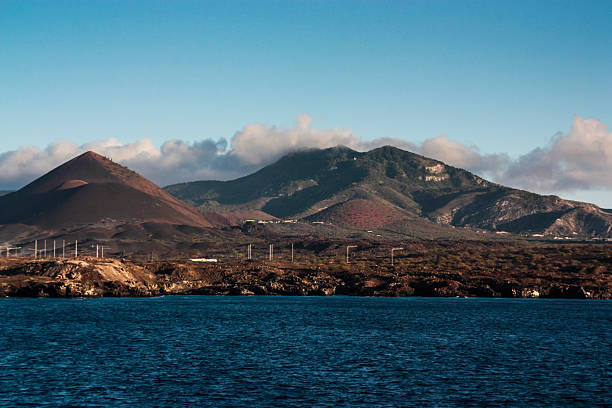 Various radar and radio masts in the lava fields on Ascension Island, with Green Mountain in the background.