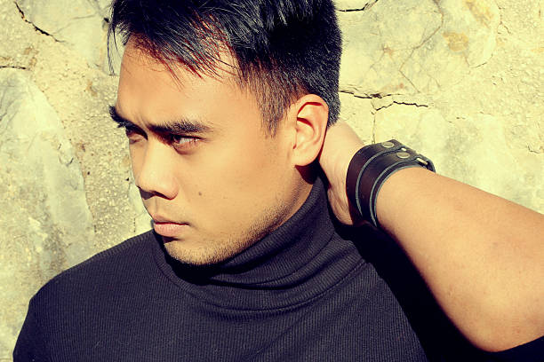 istock handsome Asian man holding his head 530888119