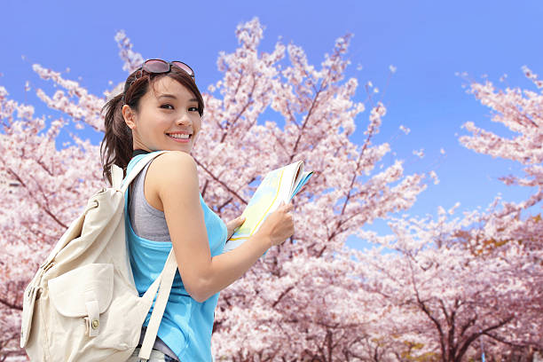 Happy travel woman with sakura tree