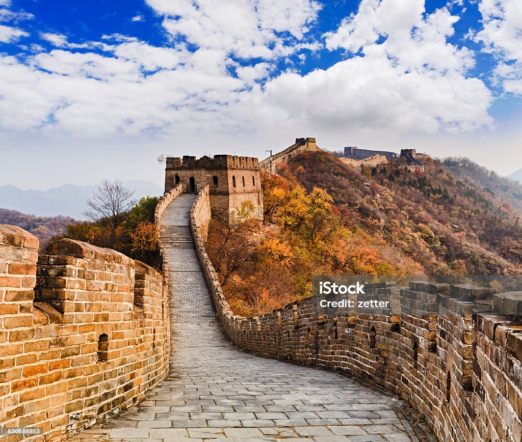 China Great Wall Up Yellow The Great wall of China ancient national architectural landmakrs high in Mutianyu mountains under blue sky tracing away Mutianyu Stock Photo