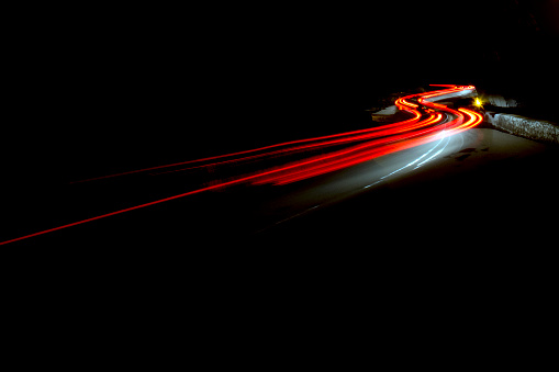red and white Car light trails in the tunnel. Art image . Long exposure photo taken in a tunnel