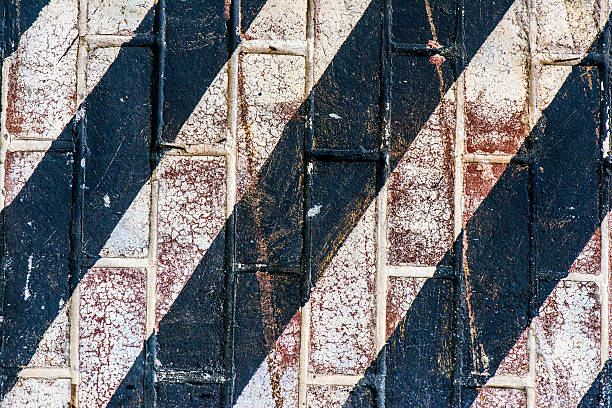 istock Painted Brick Wall With Diagonal Black Stripes 530889435