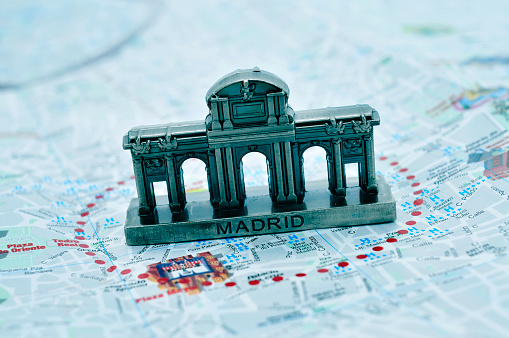 a miniature of the Puerta de Alcala on a map of Madrid, Spain