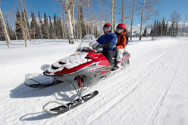 istock Couple Sitting on Snowmobile 530902429