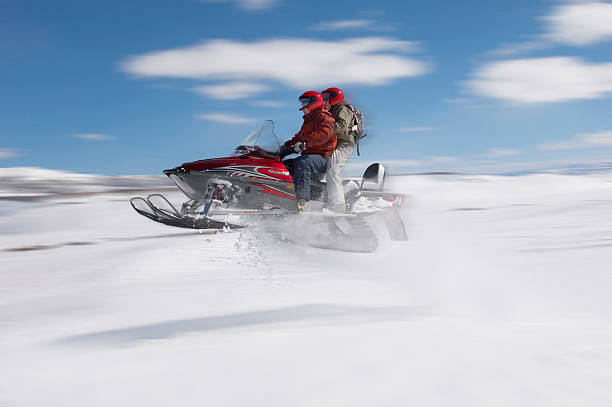 istock Couple Mid-air on Snowmobile 530902465