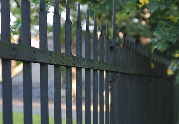 istock rust iron castle fence in sunny day 530902825