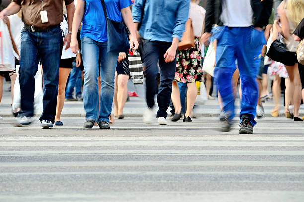 istock Motion blurred pedestrians crossing sunlit street 530903303