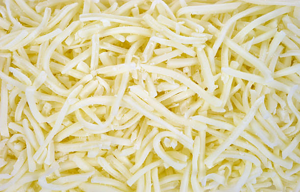 Low fat mozzarella cheese close view A very close view of low fat mozzarella cheese. shredded mozzarella stock pictures, royalty-free photos & images