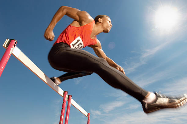 istock Male Athlete Jumping Over A Hurdles 530905443