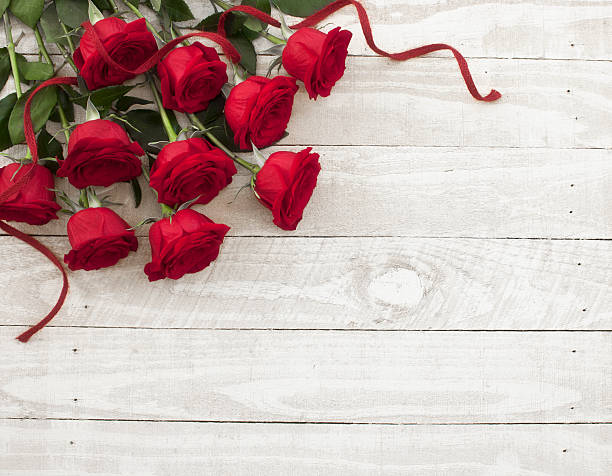 istock Valentine's day red roses bouquet on old rustic wood table 530905739