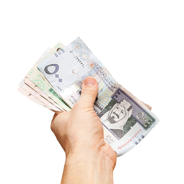 istock Saudi Arabia money. Banknotes in hand isolated on white 530907293