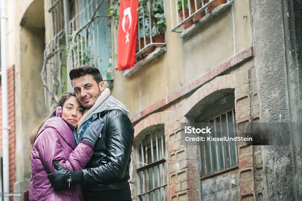 An autumn day hug in Istanbul A loving couple in Istanbul, Turkey take a stroll trough the city and hold on to each other. It's autumn and cold. Conservative Party - UK Stock Photo