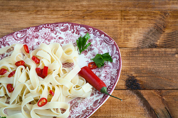 istock Fettuccini  Italian pasta with parsley and hot peppers 530916613