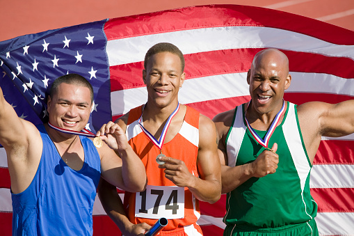 Three male athletes enjoying victory, portrait