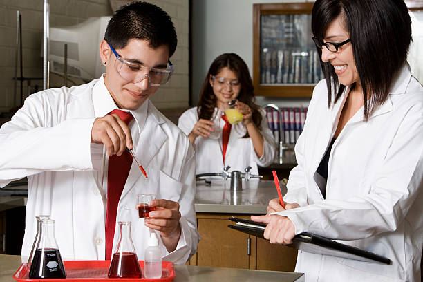 istock Professor With Students In Chemistry Lab 530917137