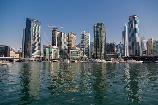 Dubai, United Arab Emirates - January 16, 2014: View at modern skyscrapers in Dubai Marina in Dubai, UAE. When the entire development is complete, it will accommodate more than 120,000 people.