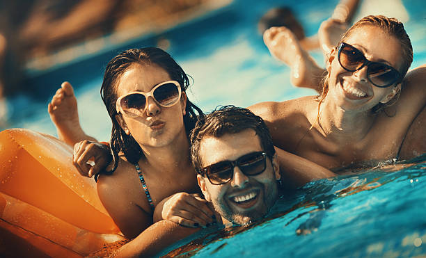 istock Friends having fun in a swimming pool. 530918380