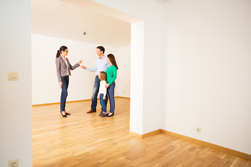 Real Estate Agent giving a family the key to their new apartment