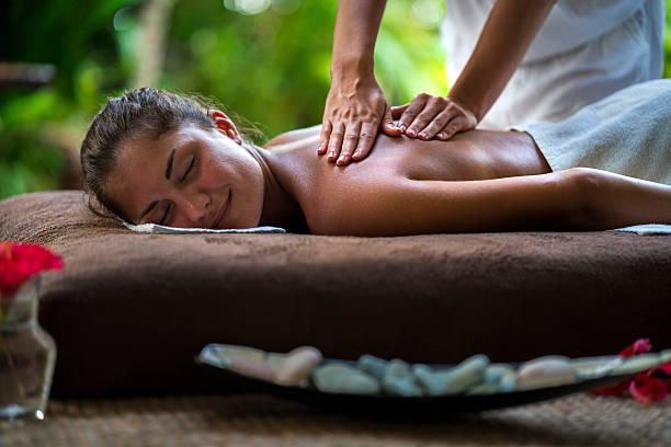 istock Smiling woman enjoying in a back massage at the spa. 530918516