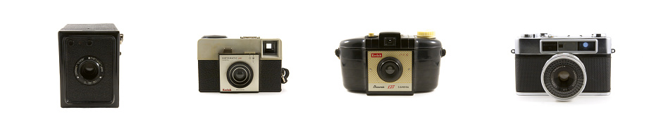 Vancouver, Canada - January 2, 2015: Four vintage cameras isolated on white backgrounds. Included are the Coronet Every, Kodak Brownie, Kodak Instamatic and Yashica Minister III. 