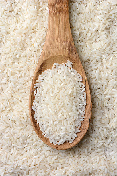 istock Rice and Wooden Spoon Closeup 530920683