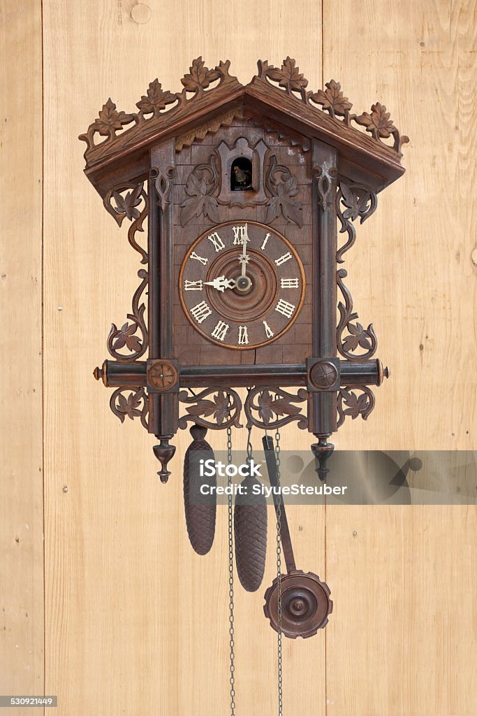 Antique cuckoo clock, (made in 1798) Antique cuckoo clock, (made in 1798) on wooden wall Art And Craft Stock Photo