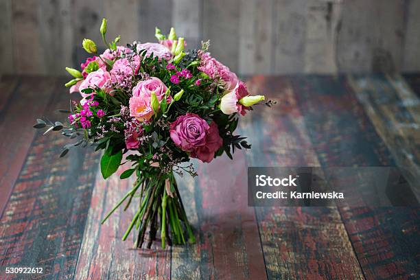 Rustic Wedding Bouquet With Pink Roses And Lisianthus Flowers Stock Photo - Download Image Now