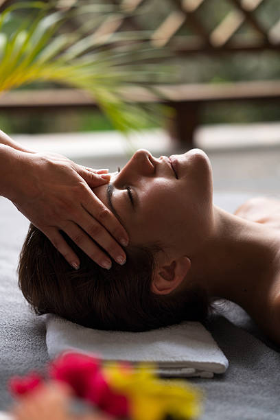 istock Young woman having a head massage at the spa. 530923464