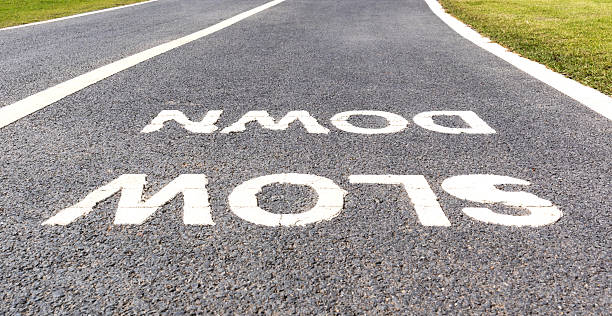 istock Warning sign to slow down marked on street, safety concept. 530925674