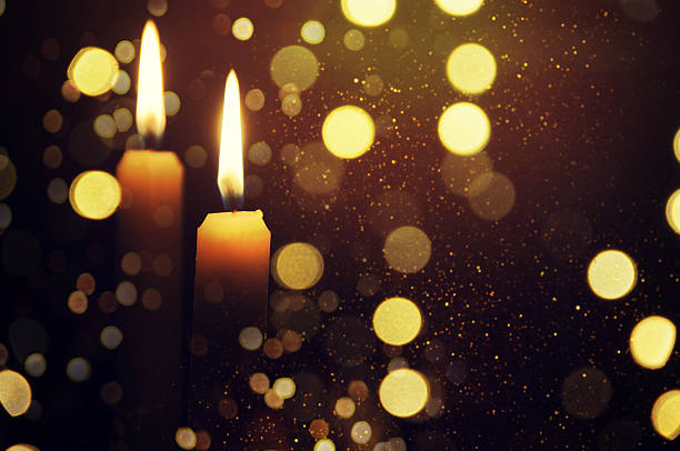 istock Candle with a flame brighter than the Christmas tree behind 530927000