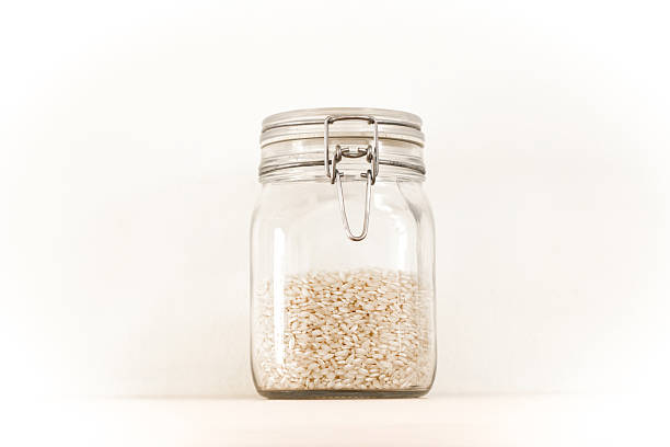 Raw White Rice in Mason Jar, White Background, Copy Space
