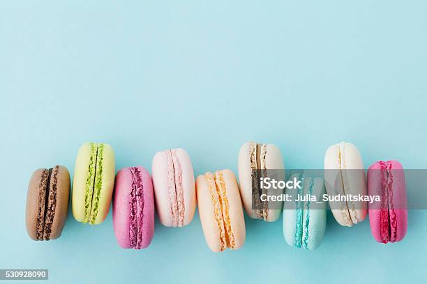 Cake Macaron Or Macaroon On Turquoise Background Pastel Colors Stock Photo - Download Image Now