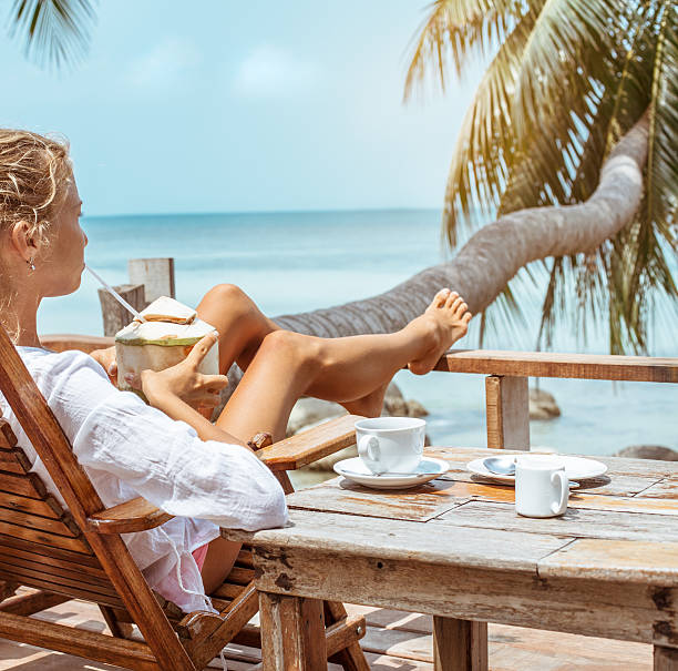 istock Young woman enjoys drinking coffee and coconut 530928238