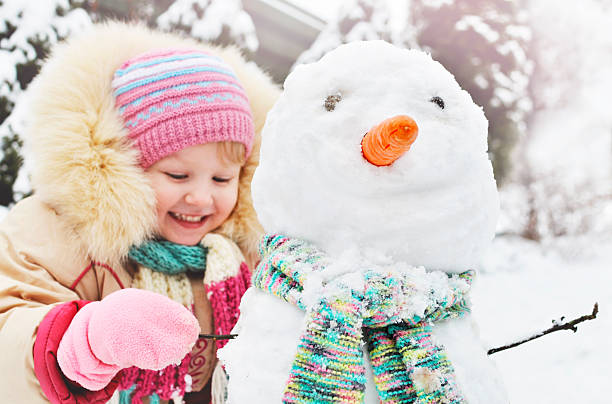 istock Little girl makes snowman 530929315
