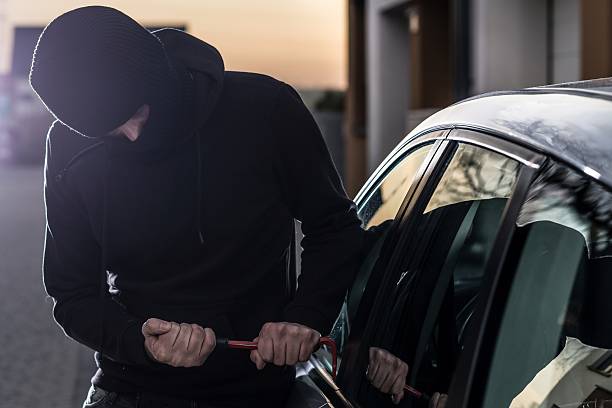istock Car Thief tries to break into car with crowbar 530929534