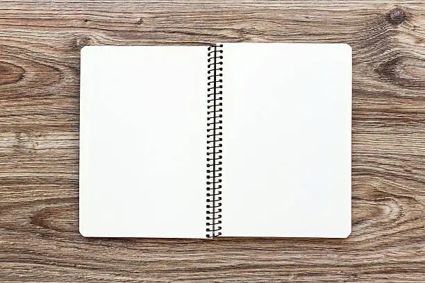 Mockup of open notepad with blank pages on wooden background. Template for your design. Top view.