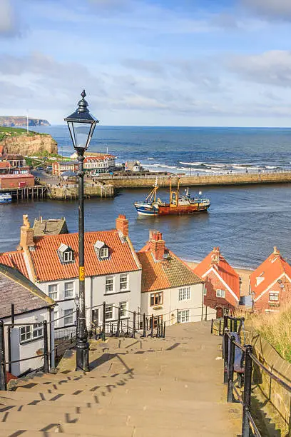 One by one, the fishing fleet returns to Whitby Harbour.  Taken from the famous 199 steps.