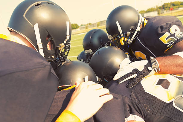 istock Football players huddled before game on field 530930509