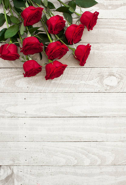istock Valentine's day red roses bouquet on old rustic wood table 530930639