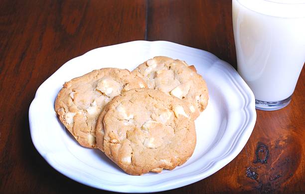 Cookies and Milk Photograph of white chocolate chip cookies and a glass of milk. chocolate white chocolate chocolate chip white stock pictures, royalty-free photos & images