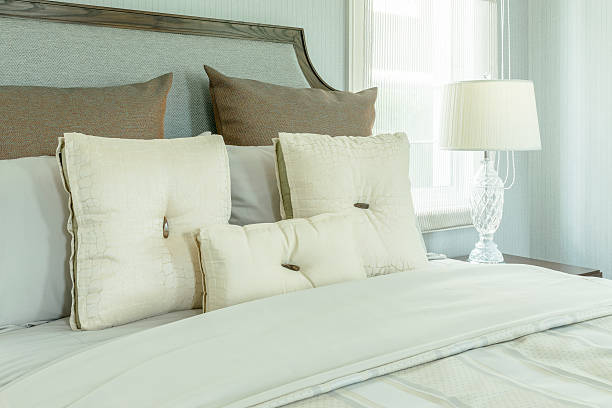 istock cozy bedroom interior with white pillows and reading lamp 530931380
