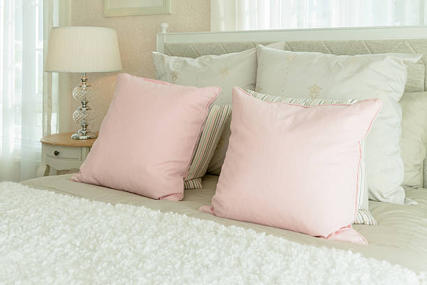 istock luxury bedroom interior with pink pillows and reading lamp 530931448