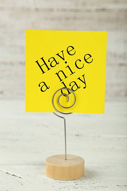 istock Yellow note paper on a holder on white wooden background 530931834