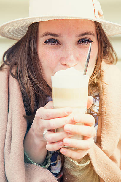 istock young woman sitting at Cafe with coffee 530932654