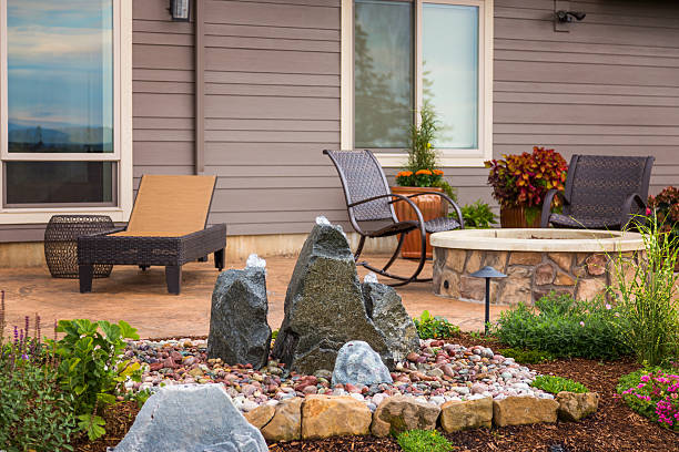 istock Outdoor Patio with Water Feature, Fire Pit, and Reclining Chairs 530932857