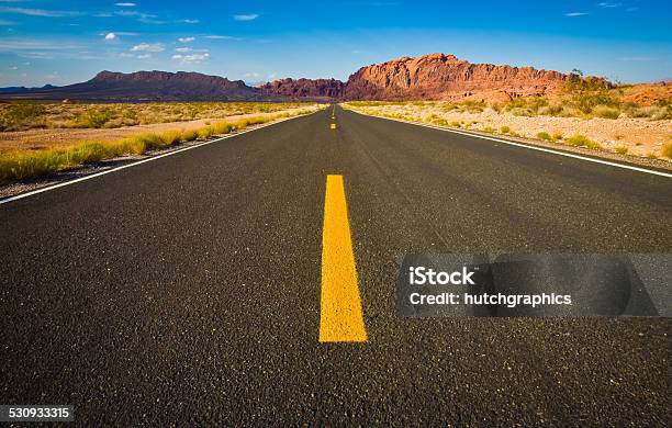 Road View Towards Mountains In Desert Stock Photo - Download Image Now - Asphalt, Backgrounds, Blue