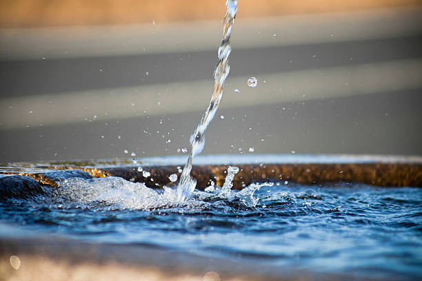 Water surface and spurt with copy space on the right. Image of a drinking water fountain suitable for nature or water conservation background.