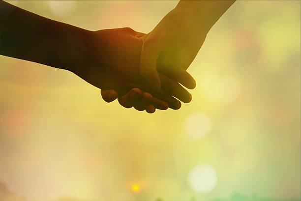 istock couple holding hands in soft pastel tone 530934988