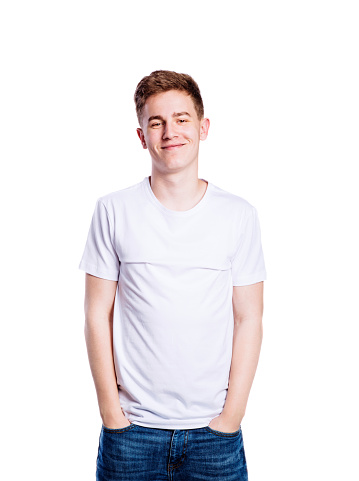 Teenage boy in jeans and white t-shirt, young man, studio shot on white background